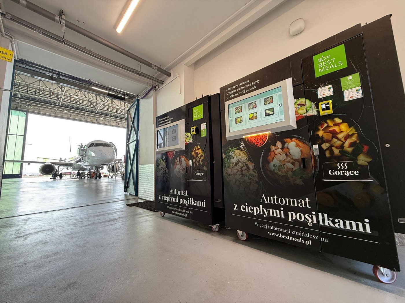 Two Best Meals MIDA machines beside an aircraft hangar